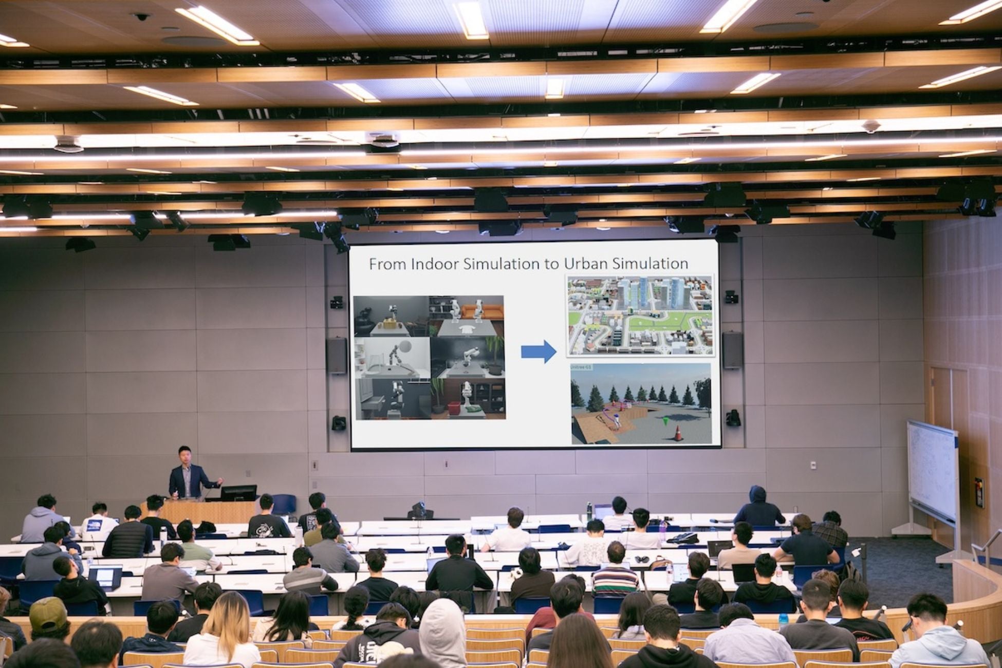 UCLA Professor Bolei Zhou teaches an engineering course in a room full of students