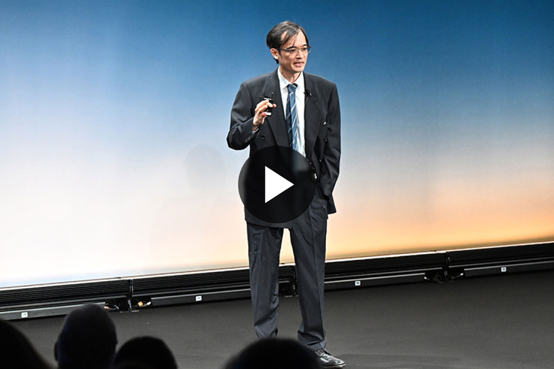 Terrance Tao speaking on a stage